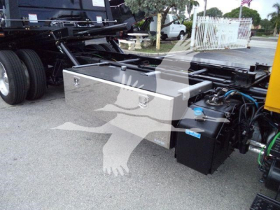 Truck chassis with utility toolbox and battery/auxiliary box visible under the frame, 2019 International 4300 rollback.