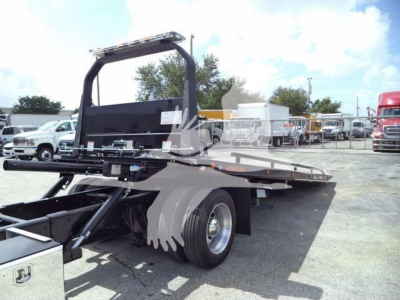 2019 International 4300 rollback truck shown from rear-left side with flatbed and hydraulic system