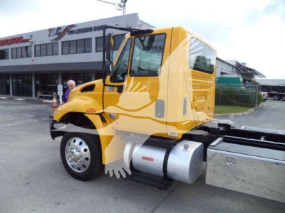 2019 International 4300 rollback truck cab with yellow color, side view showing fuel tank and chassis.