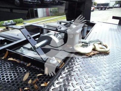 Truck bed with hydraulic winch and hook assembly, mounting hardware, and diamond plate surface.