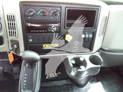 Dashboard and center console of a 2019 International 4300 truck showing instrument cluster, HVAC controls, radio, cup holders, and ignition area.