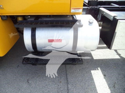 Truck fuel tank with label reading DENS..?? Diesel fuel only (partial) and steps beneath the tank.