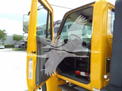 1999 International 4300 rollback truck cab interior and open door showing steering and dashboard.