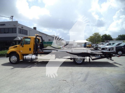 2019 International 4300 rollback tow truck side view showing cab and flatbed with branding not legible.