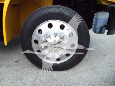 Truck wheel and tire close-up on a 2019 International 4300 rollback truck showing front duals and chrome hub with lug nuts.