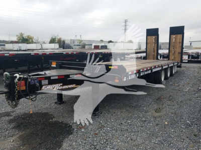 Flatbed trailer showing dual axles and goose-neck style front with ramps up, brand 'Eager Beaver' decals visible on side.