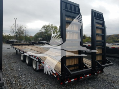 Trailer flatbed with dual ramps in upright position, black steel frame, wooden deck, multiple axles, reflective tape along sides.