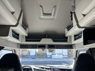 Volvo VNL64T860 cab interior with overhead bunk storage and cockpit view.