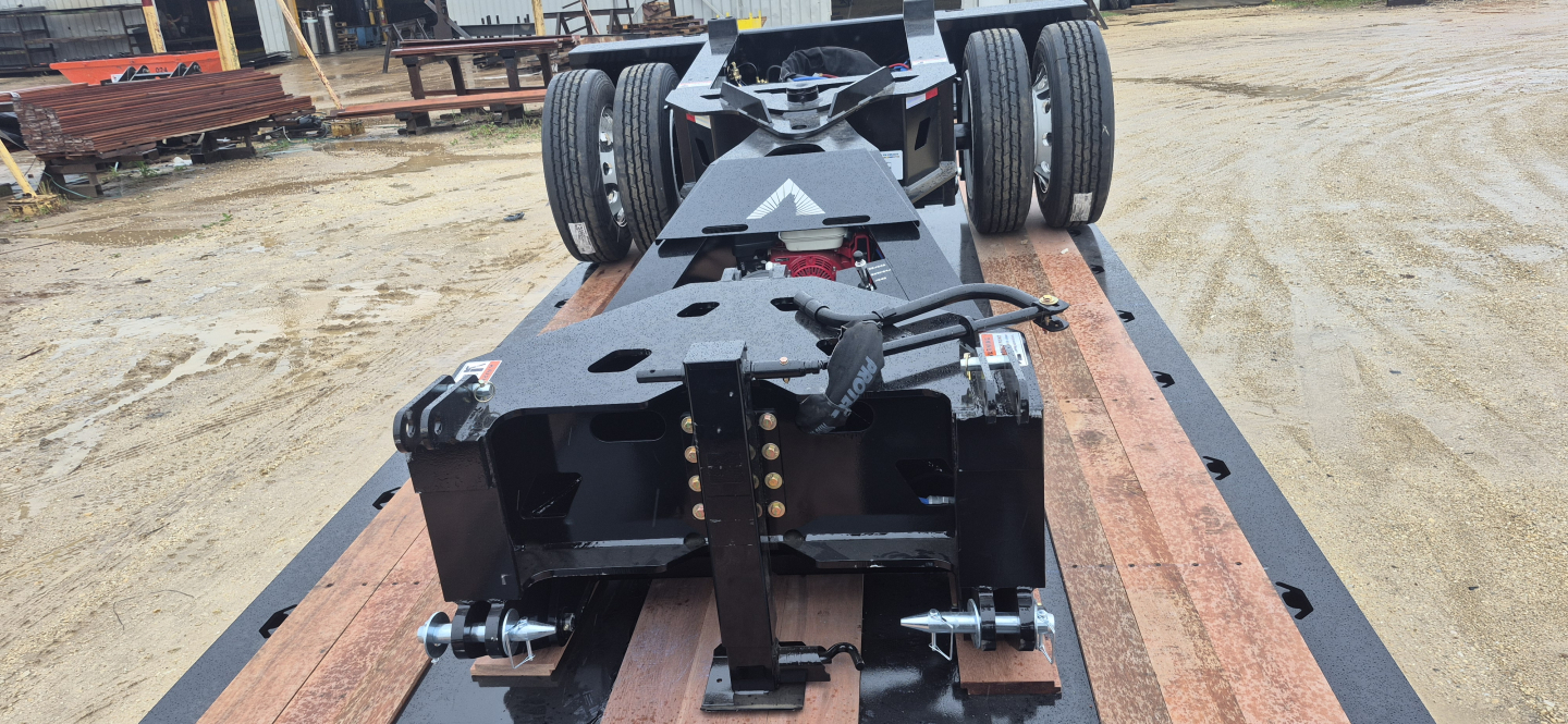 Trailer deck showing Alpha ANSB1 Nitro Spreader Bar assembly with 55-ton capacity and 8'6" width, rear wheels and hitch mounting points.