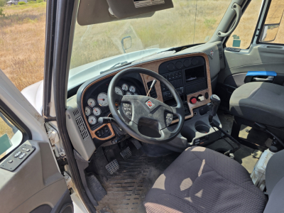 Interior cab view of 2009 International Prostar daytime cab showing steering wheel dashboard gauges and gear shifter