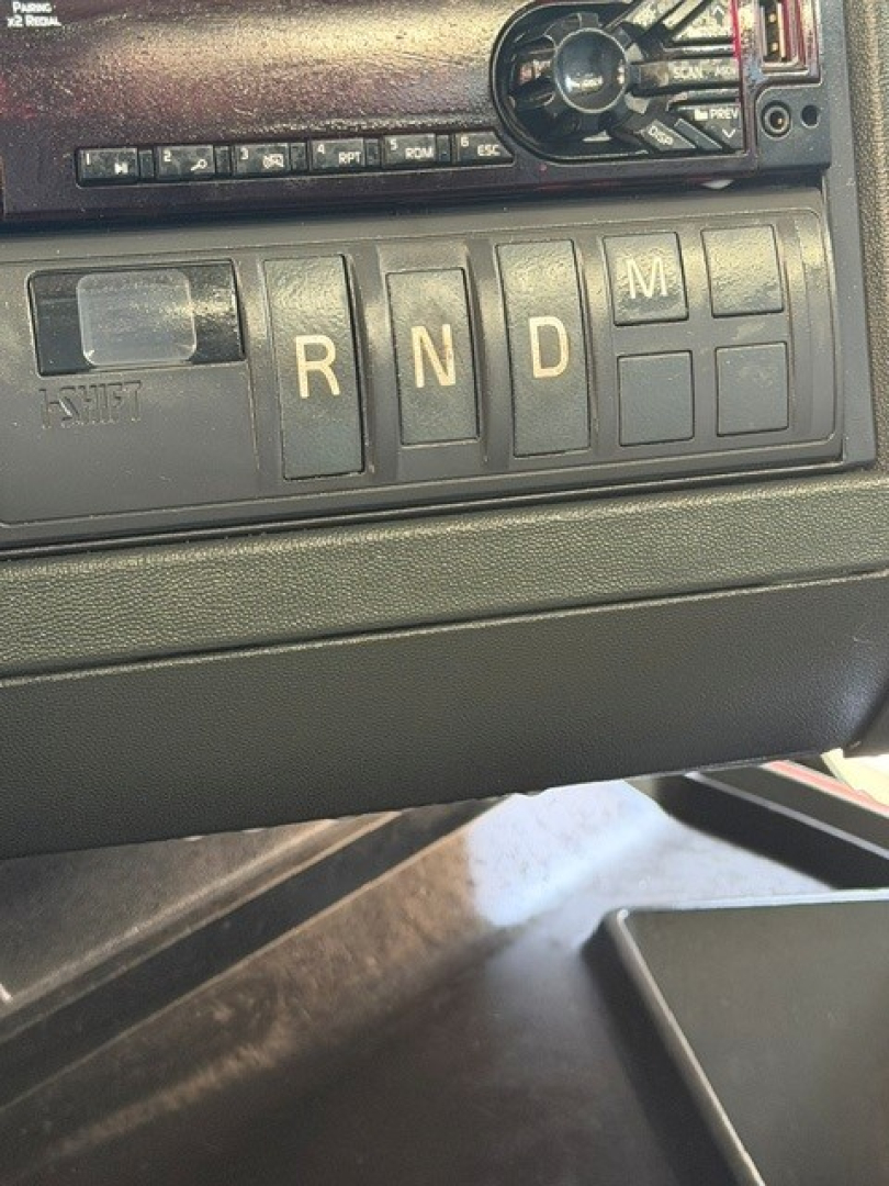 Vehicle gear selection in cab showing PRNDM switches of a 2018 Volvo VNR.