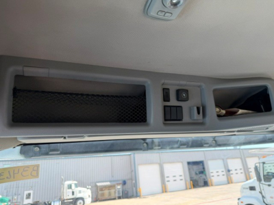 Volvo VNR64T300 cab interior overhead console showing storage pocket, switch panel, and storage cubby.