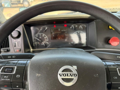 Volvo VNR64T300 truck cabin interior showing steering wheel with Volvo emblem and dashboard gauges.