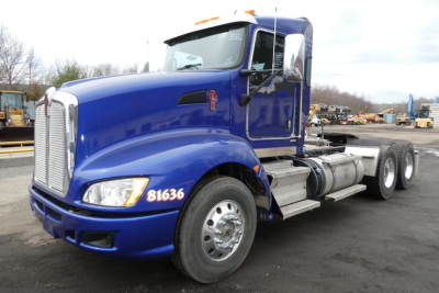 Blue Kenworth T660 conventional daycab truck, front three-quarter view, with stock number 1007251 and VIN 1XKAD49X4DJ361932 visible.