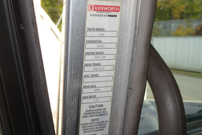 Kenworth T660 cab door jamb label with truck model, chassis, and engine info visible. Label shows 'KENWORTH', 'TRUCK MODEL', 'T660', 'CHASSIS NO', 'ENGINE MODEL', and other spec boxes.