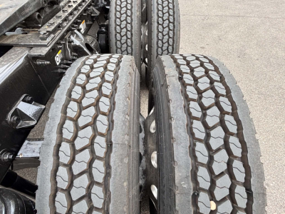 Kenworth T680 truck rear dual tires with tread pattern visible in the image view, chassis components and suspension nearby.