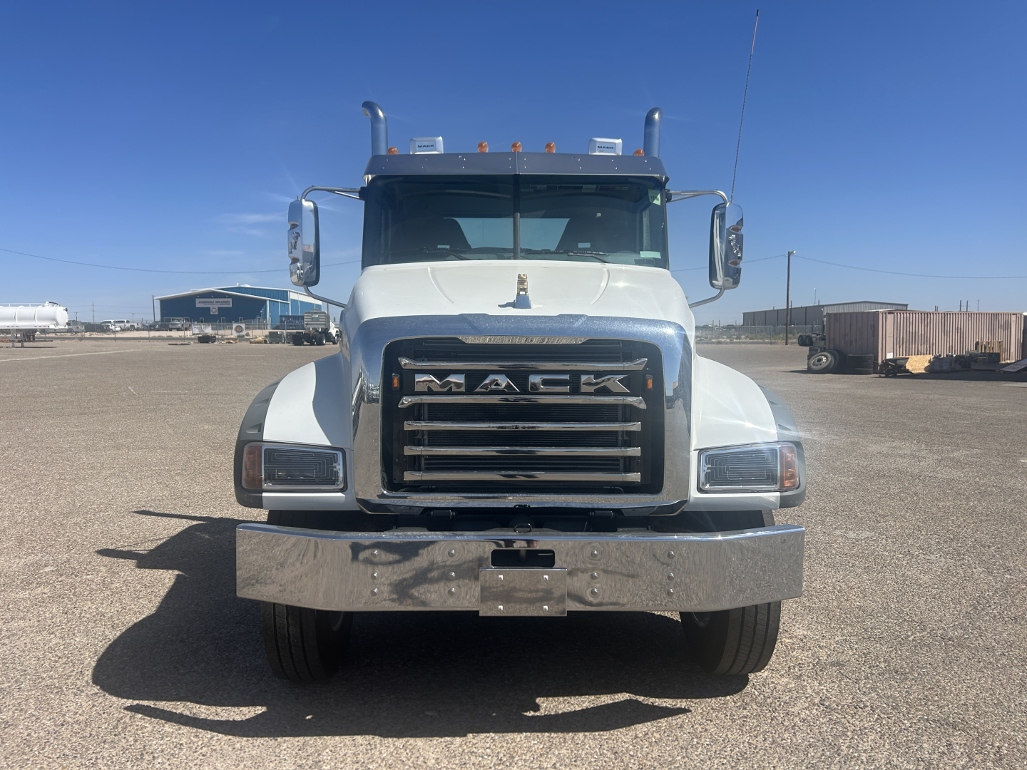 Mack GR64FT conventional daycab truck front view showing large chrome grille with MACK lettering and bumper.