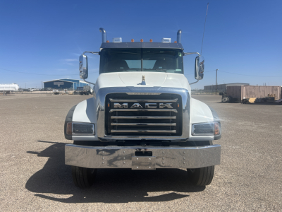 Mack GR64FT conventional daycab truck front view showing large chrome grille with MACK lettering and bumper.