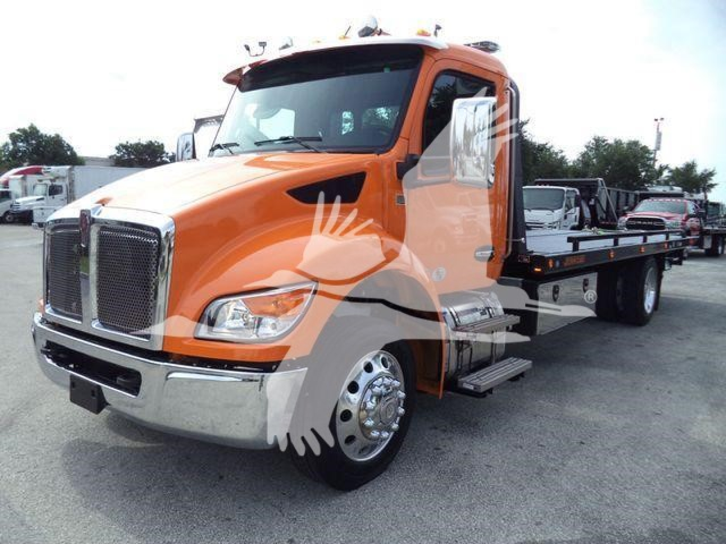 Kenworth T280 rollback truck in orange, front-left view showing flatbed and chrome bumper.