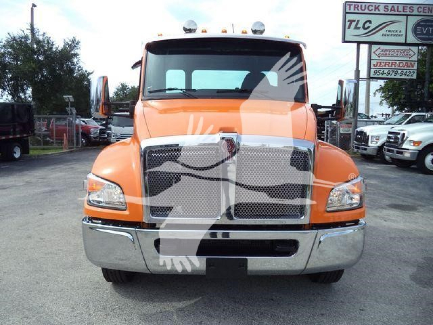 Kenworth T280 rollback truck front view in orange with chrome bumper and grille, stock number T280ORANGE22XLP visible in background.
