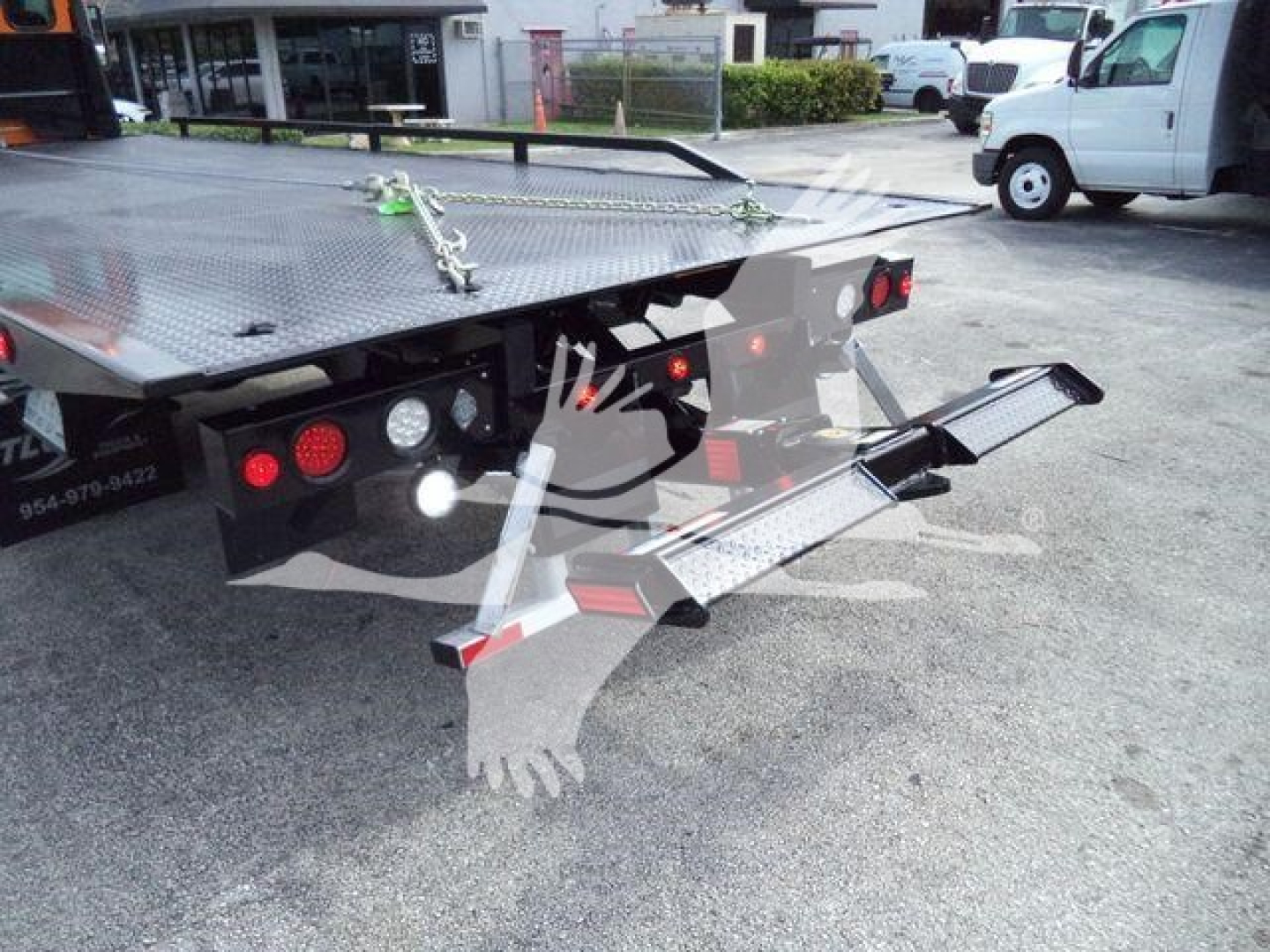Kenworth T280 rollback bed rear view showing platform and fold-down ramps with rear lights.