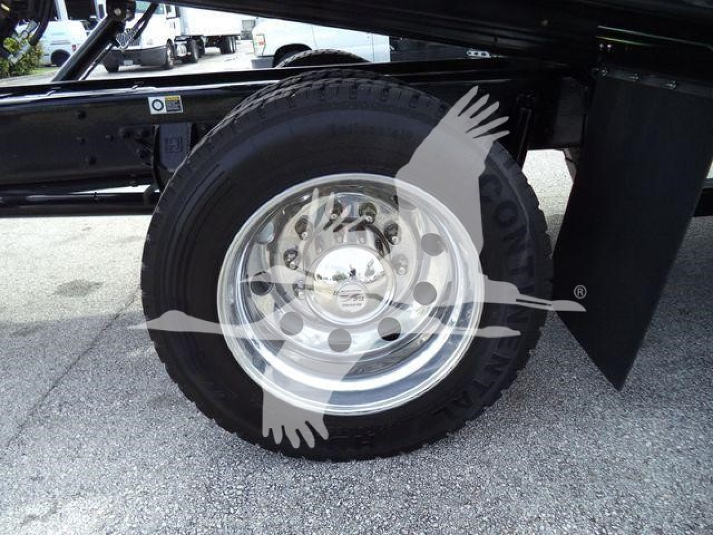 Truck wheel and dual rear axle area showing a polished steel rim and black tire on Kenworth T280 rollback chassis.