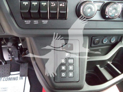 Kenworth T280 center console with gear selector and climate controls; visible labels include P R N D and up/down arrows on the shift panel.