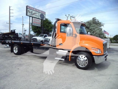 Kenworth T280 rollback truck in orange with flatbed, side view showing cab, chrome wheels, and towing platform.