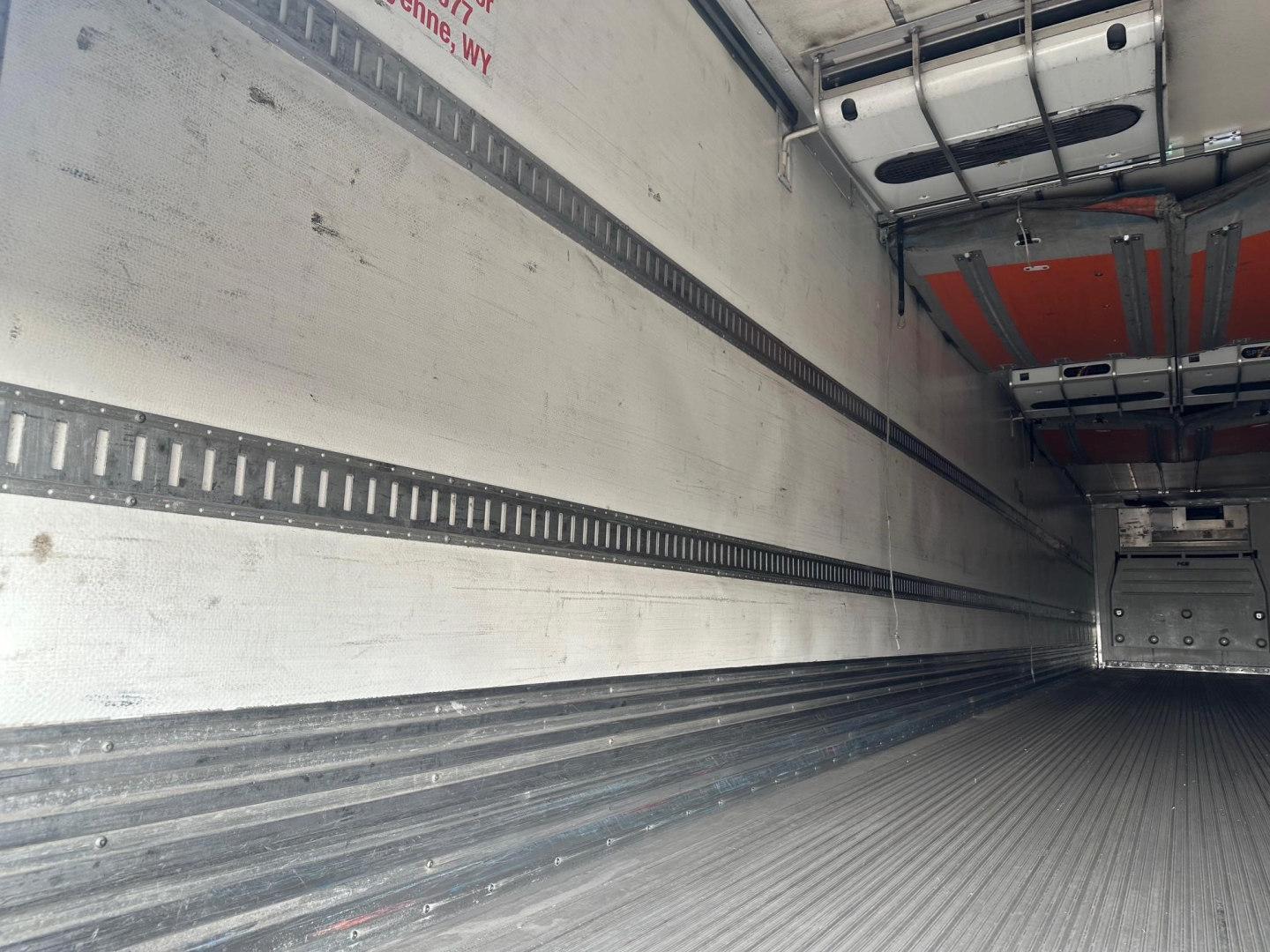 Interior of a 53' Great Dane reefer trailer cargo area showing ribbed side walls and floor with tie rails.