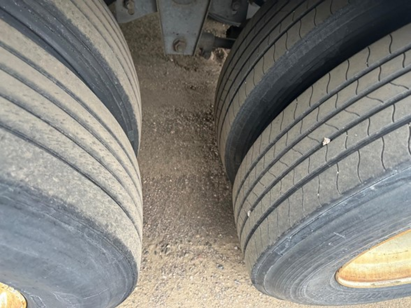 Great Dane trailer view showing dual rear wheels and mud guard; close-up of tire treads and wheel rims.