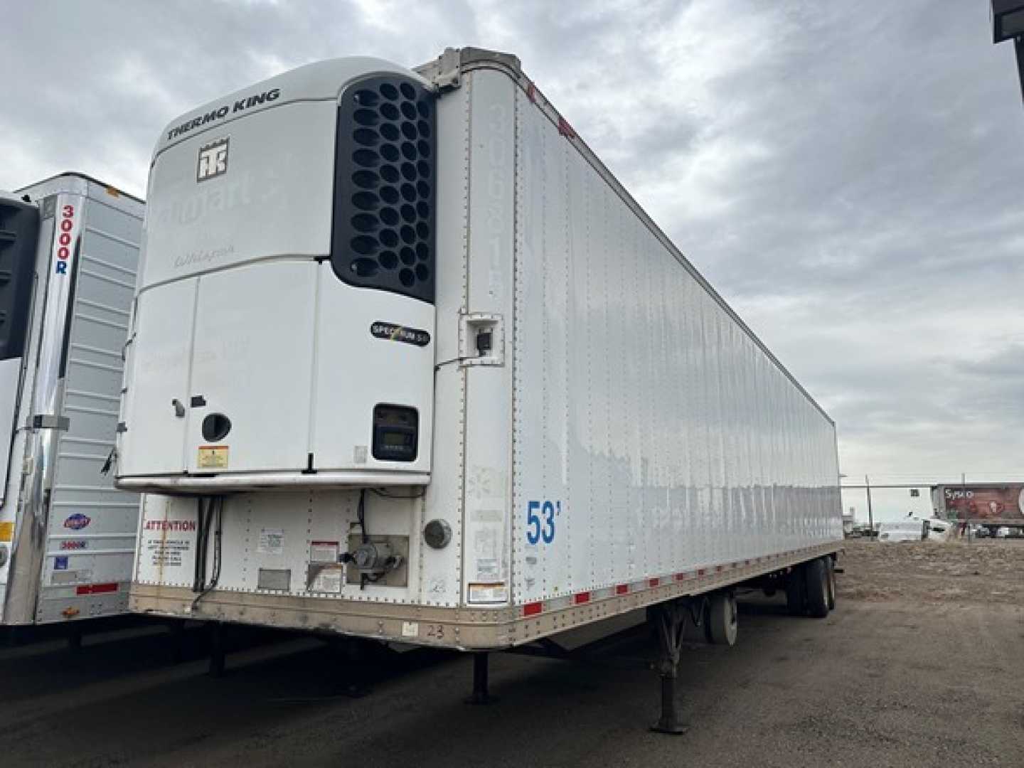 Great Dane roll door reefer trailer showing Thermo King unit on front, white exterior, 53' length, side rails, landing gear, and elevated refrigeration unit.