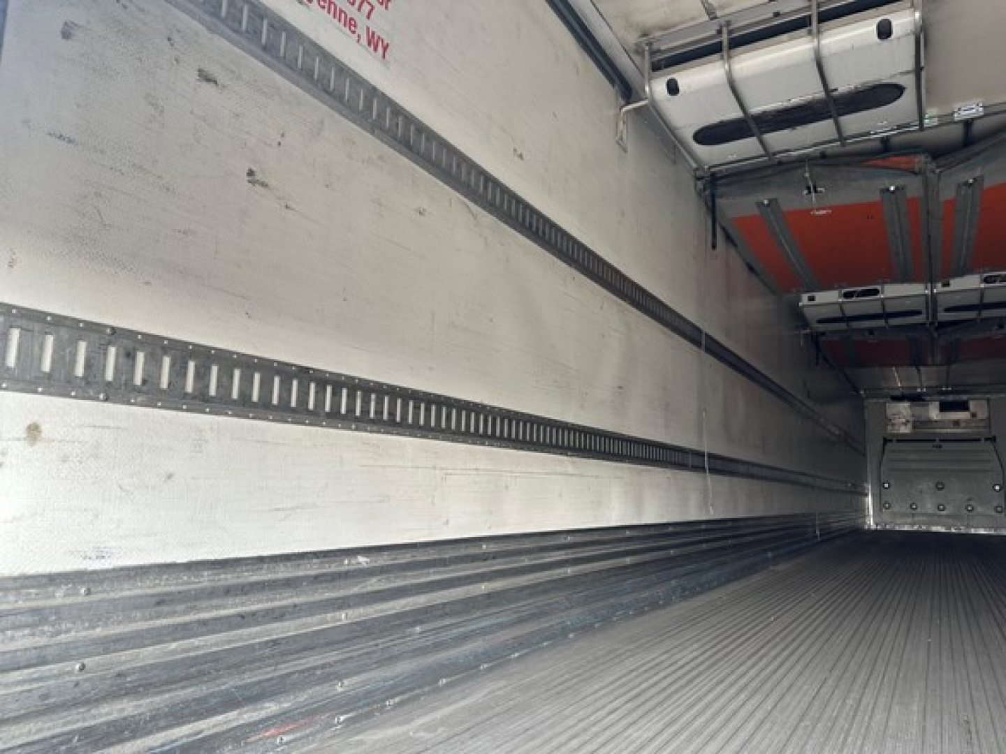 Great Dane roll door reefer trailer interior showing aluminum side walls with E-track rails and ribbed floor.