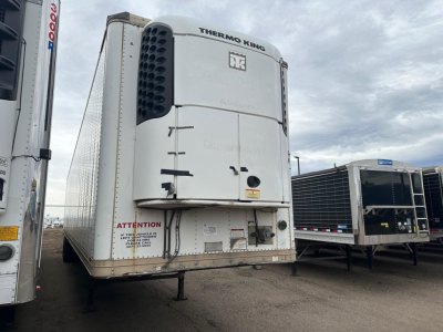 Thermo King multi-temperature reefer trailer front view showing Thermo King unit and Twin-axle cargo area.