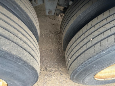 Great Dane trailer view showing dual rear wheels and mud guard; close-up of tire treads and wheel rims.