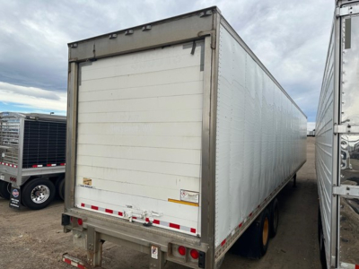 Trailer side and rear showing a white Great Dane roll door reefer trailer with rear bumper and red/white reflective markings.