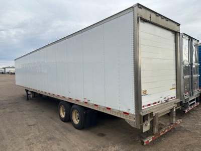 Great Dane roll door reefer trailer viewed from rear-right side showing white insulated chassis and dual rear doors.
