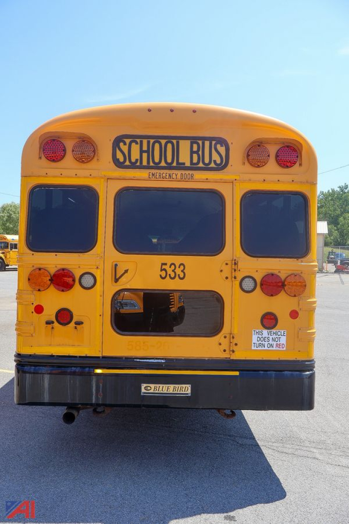 Yellow 2018 Blue Bird Vision school bus rear view with emergency door, tail lights, plate and school bus signage.