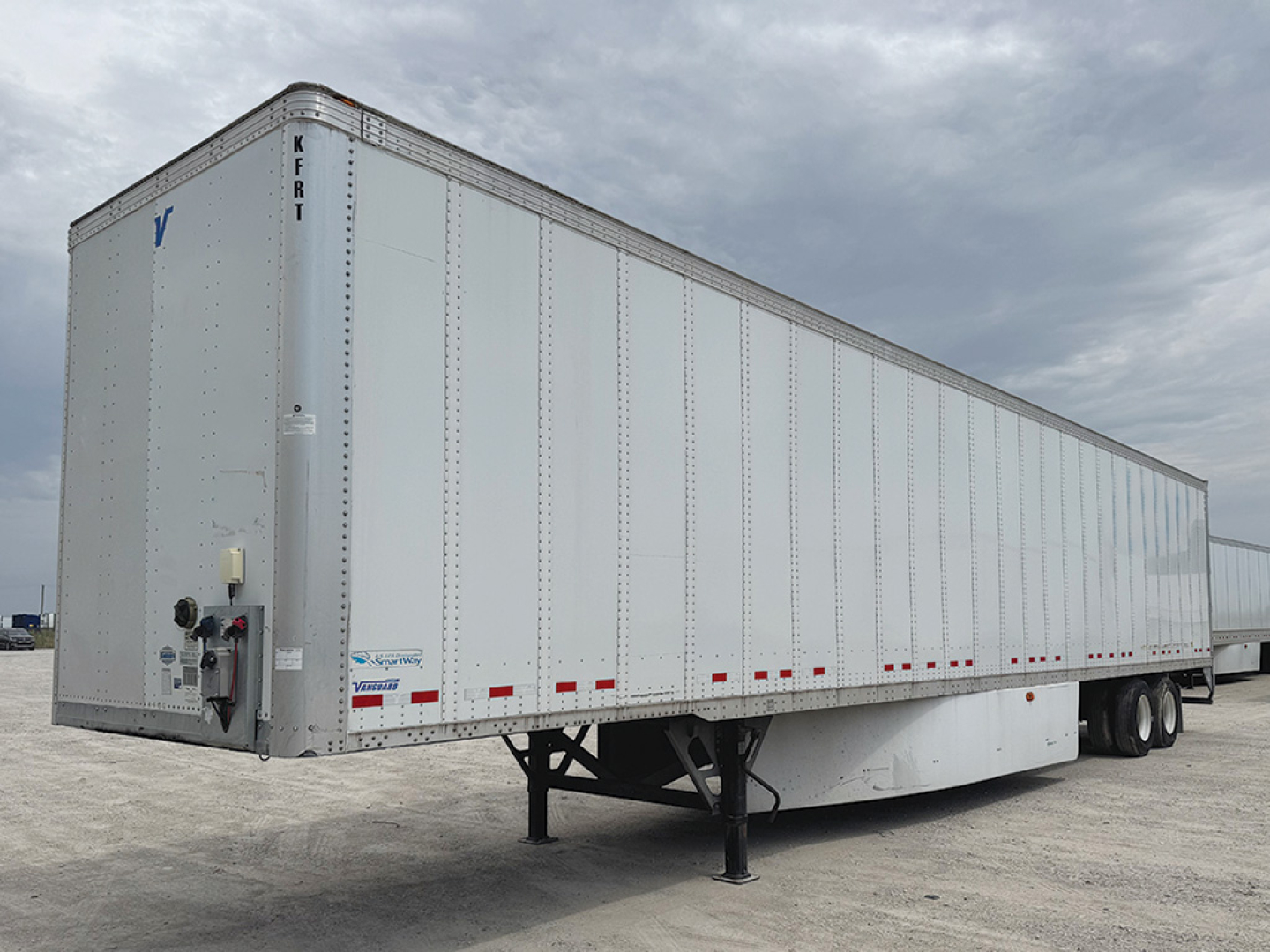 Trailer side view of a Vanguard VXP box trailer with landing gear and dual rear axles.