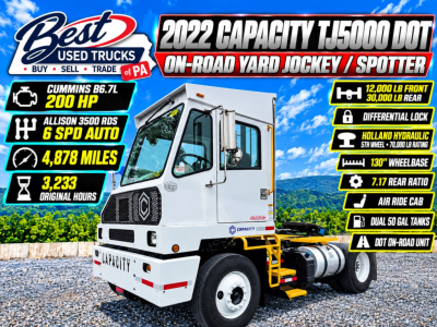 Capacity TJ5000 DOT on-road yard jockey/spotter truck showing 12,000 lb front/30,000 lb rear, dual 50 gal tanks, 130 inch wheelbase, Allison 6SPD auto, Cummins B6.7L 200 HP, Holland hydraulic, air ride cab, differential lock, rear engine ba