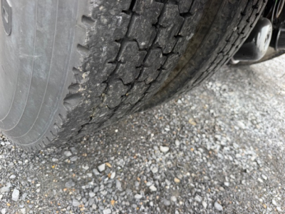 Rear wheel and tire tread along with part of trailer hitch visible; no legible model or serial text in view.