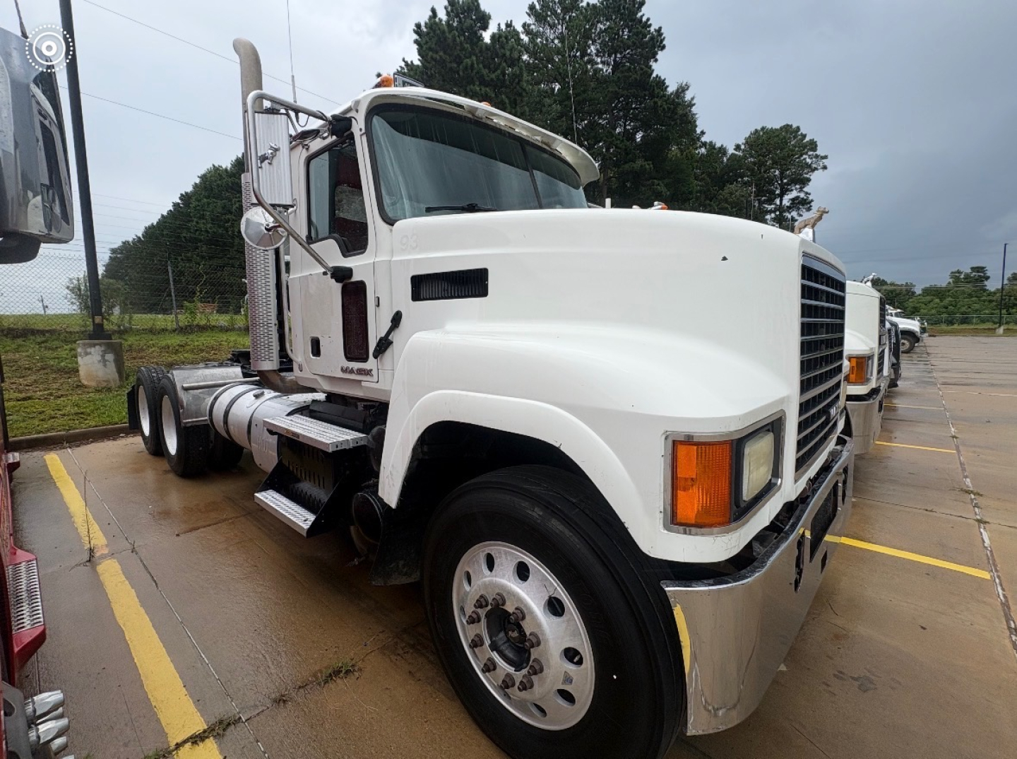 Front three-quarter view of a white 2016 Mack CHU613 conventional daycab truck showing cab, grille, headlights, and large front bumper.