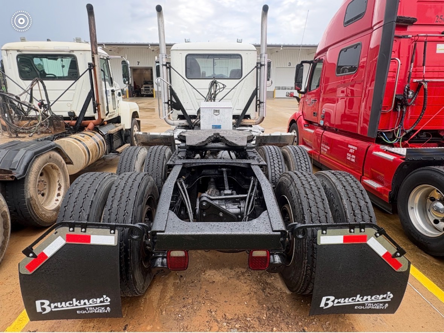Mack CHU613 rear view showing dual rear axles and mud flaps with Bruckners Branding.