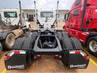 Mack CHU613 rear view showing dual rear axles and mud flaps with Bruckners Branding.