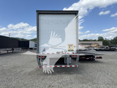 Rear view of a Hyundai Roll Door Van trailer showing roll-up rear door and reflective safety decals.