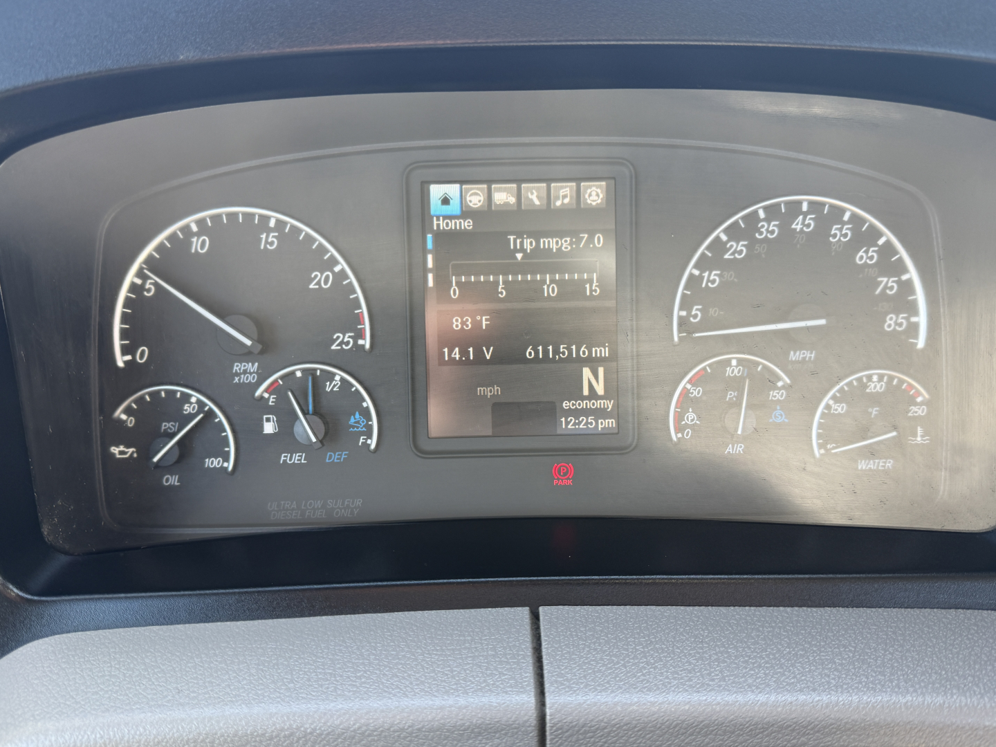 Instrument cluster of a Freightliner PT126064S T showing digital trip computer and gauges, with RPM, speedo, fuel, oil pressure, and battery indicators visible.