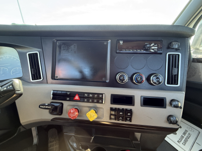 Dashboard of Freightliner truck cab showing empty instrument panel, climate controls, ignition area, AC vents, and various switches.