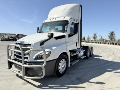 Truck engine bay not visible; Freightliner PT126064S T conventional daycab truck front-left view with grille guard.
