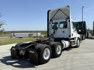Freightliner PT126064S T cab tractor rear view showing fifth wheel area, dual rear axles, white cab, taillights, and mud flaps.