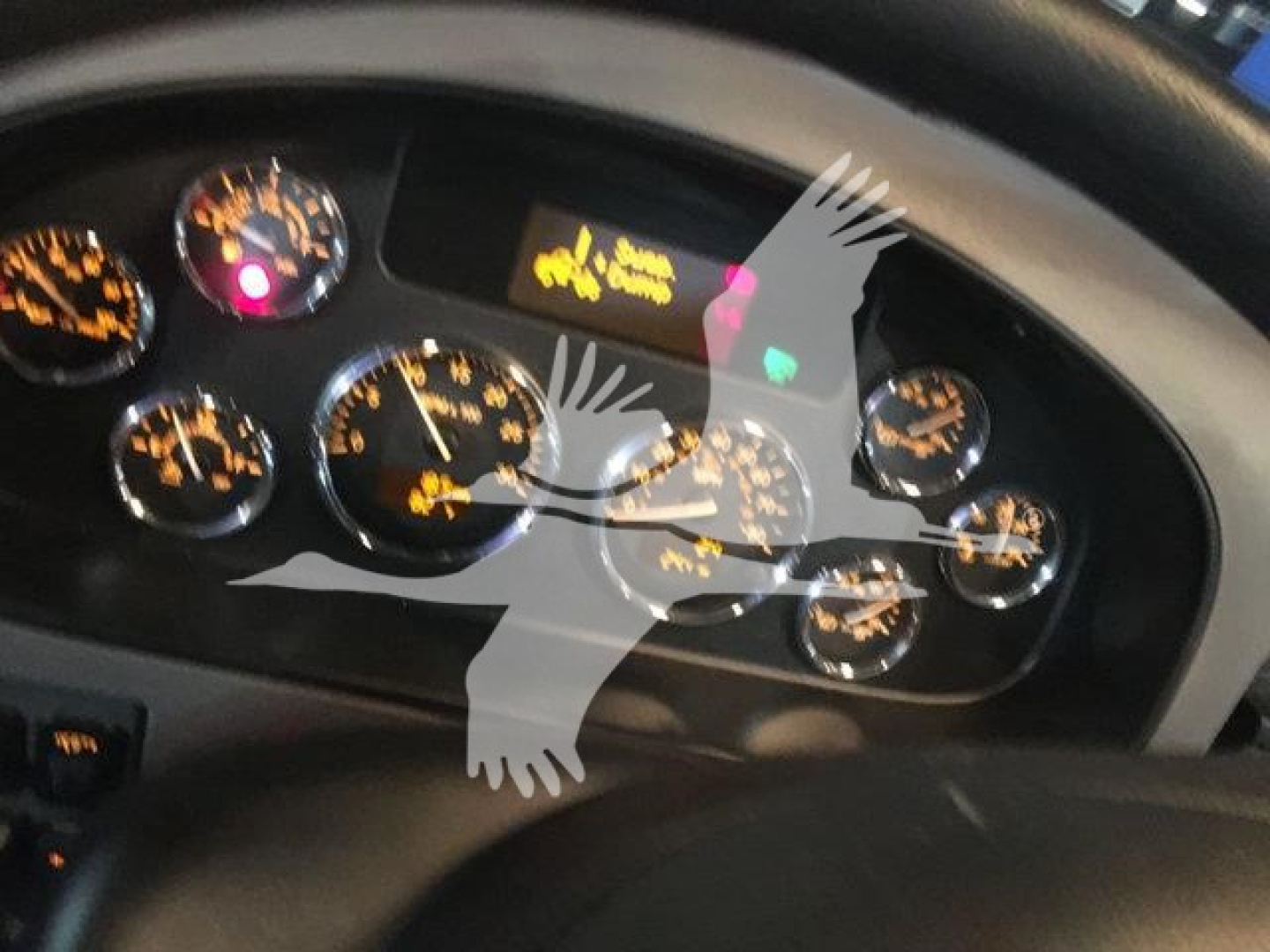 Dashboard gauges of a 2022 Peterbilt 337 showing multiple analog dials and warning lights.