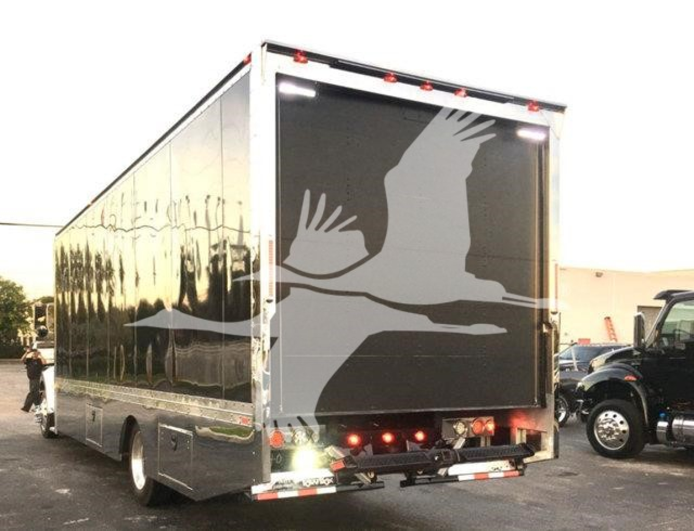 Truck rear view with a large enclosed trailer, Peterbilt 337, rollback stock image. Visible text includes stock number J56602, category Rollback, type Trucks, new/used New.